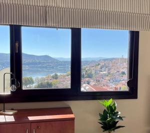 two windows in a room with a view of a city at Belvedere garden in Kastoria