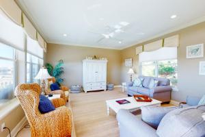 a living room with a couch and a table at Serenity Now in St. George Island