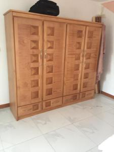 a wooden cabinet with drawers in a room at tina house in Bel Ombre