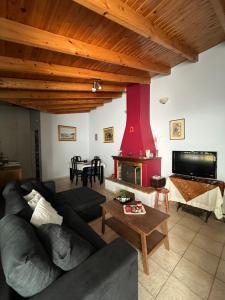 a living room with a couch and a table at House near the Athens Airport, Spata. in Spata