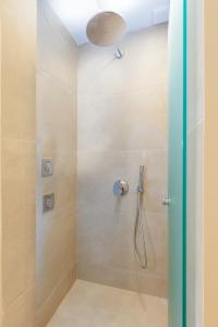 a shower with a shower head in a bathroom at KALES SEA VIEW SUITES in Ierápetra