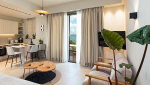 a living room and kitchen with a couch and a table at Kales Sea View Suites in Ierapetra in Ierapetra