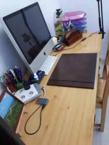 a desk with a laptop computer on top of it at Les écureuils bourguignons in Montchanin