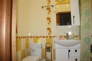 a bathroom with a toilet and a sink at Apartment Voykova 23 in Sochi