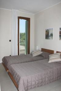 Katil atau katil-katil dalam bilik di Grillo Casa Vacanze