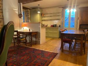 a kitchen with a table and a dining room at Chez Katia in Semur-en-Auxois
