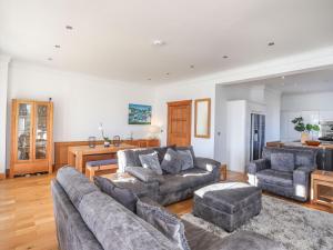 a living room with a couch and two chairs and a table at Bryn Mel Manor Straits View in Menai Bridge