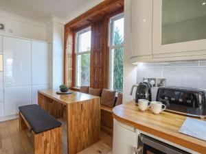 a kitchen with a wooden counter top and a sink at Bryn Mel Manor Straits View in Menai Bridge