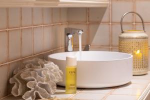 a bathroom counter with a sink and a sponge at Roslin Beach Hotel in Southend-on-Sea +70 photos