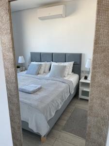 A bed or beds in a room at Ocean Garden Sunset Apartment - heated swimming pool Free WIFI