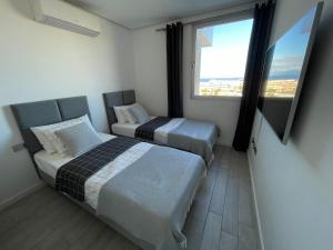 A bed or beds in a room at Ocean Garden Sunset Apartment - heated swimming pool Free WIFI
