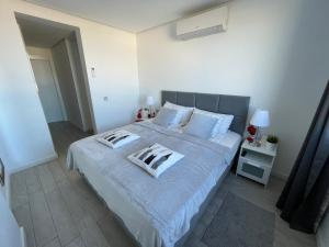 A bed or beds in a room at Ocean Garden Sunset Apartment - heated swimming pool Free WIFI