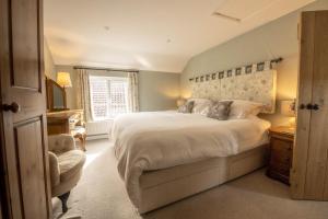 a bedroom with a large bed and a window at 1 School Lane in Malton