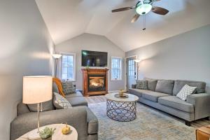 a living room with a couch and a fireplace at Beautiful Pocono Lake Cottage with Game Room! in Pocono Lake
