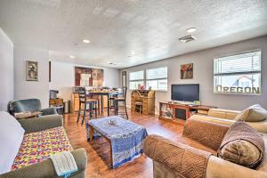 a living room with a couch and a tv and a table at Springfield Apt with Deck and Central Location! in Springfield