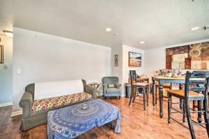 a living room with a couch and a table and chairs at Springfield Apt with Deck and Central Location! in Springfield