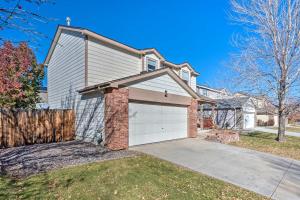 een huis met een garage en een hek bij Spacious Thornton Home with Private Backyard! in Thornton