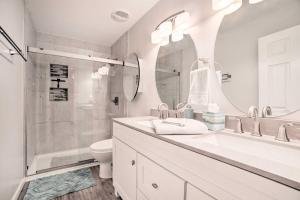 a white bathroom with a sink and a shower at Country-Chic Home with Fire Pit, Steps to Lake! in New Concord +19 photos