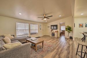 a living room with a couch and a ceiling fan at Munds Park Cabin with Wraparound Deck and Grill! in Munds Park