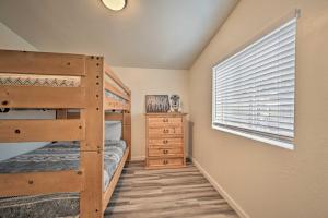 a bedroom with two bunk beds and a window at Munds Park Cabin with Wraparound Deck and Grill! in Munds Park