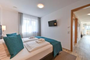 a hotel room with a bed with towels on it at Landhaus am See Appartement LH 02 in Schwangau