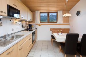 a kitchen with a sink and a table in a room at Salenberghof Ferienwohnung Bergsee in Rieden