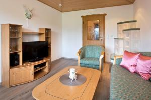 a living room with a couch and a table at Salenberghof Ferienwohnung Traumblick in Rieden am Forggensee