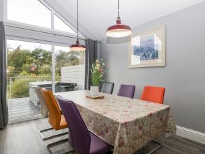 a dining room with a table and chairs at 2 Oak Park in Tiverton