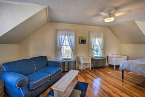 a living room with a couch and a bed at Charming Saco Apartment about 4 Mi to the Beach! in Saco
