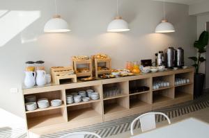 a kitchen with a shelf with food on it at Hotel Vip´s in Mar del Plata