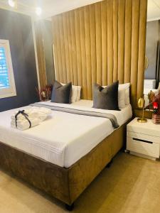 a bedroom with two beds with a headboard at Abusar Apartment in Boksburg