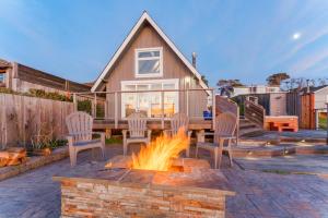 a patio with a fire pit in front of a house at Puffin's Perch in Fort Bragg