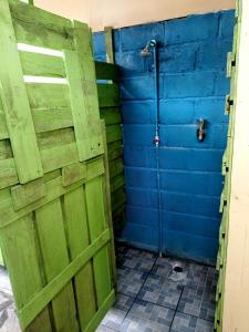 an open door in a room with a blue and green wall at Casa Yoly Hostel Granada in Granada