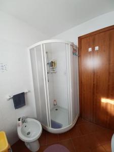 a bathroom with a shower and a toilet and a sink at casa Margherita in Massimeno