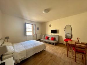 a bedroom with a bed and a desk and a mirror at Apartment Nel Centro Della Citta in Pistoia
