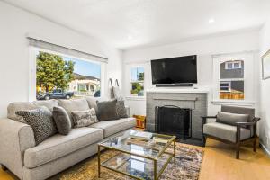 a living room with a couch and a fireplace at Mid-Town Escape in Ventura
