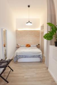 a bedroom with a bed and a potted plant at C - NOGUERA APARTMENTS - ARTS AND SCIENCIES in Valencia