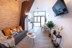 a living room with a couch and a flat screen tv at C - NOGUERA APARTMENTS - ARTS AND SCIENCIES in Valencia