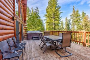 a wooden deck with a table and chairs on it at Scenic Wonders & Apt. in Yosemite West