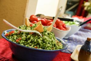 a bowl of peas and vegetables on a table at Shaar Hagolan Kibbutz Country Lodging in Shaar Hagolan