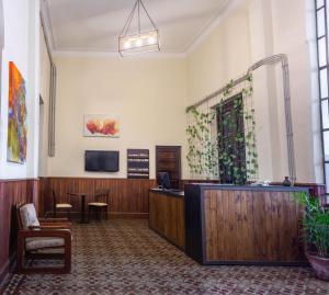 a lobby with a waiting room with a tv and a desk at HOSTEL PUNTO RAMIREZ in Salta