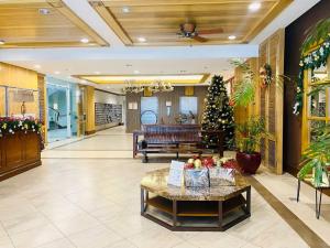 a lobby with a christmas tree and a couch at CedarPeak419 in Baguio