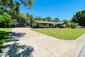 a house with a driveway leading to a yard at Convenient Home Near Airport in Fort Worth