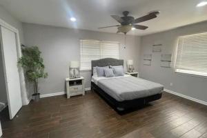 a bedroom with a bed and a ceiling fan at Convenient Home Near Airport in Fort Worth