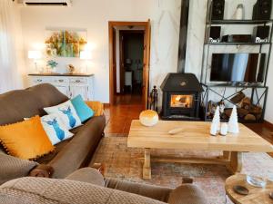 a living room with a couch and a fireplace at Villa Prana in Ávila