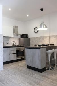 a kitchen with stainless steel appliances and a counter at Roccia Bianca in Siracusa