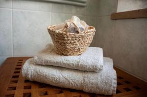 a basket of towels sitting on a table in a bathroom at Shakira Apartments in Parma +16 photos