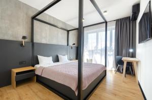 a bedroom with a bed and a large window at 18173 Black and White cozy apartment in Kyiv