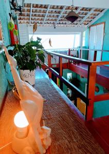 a plastic dinosaur on a table with a light at Tô na Praia Juquehy Pousada in Juquei