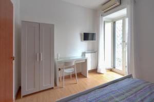 Schlafzimmer mit einem Schreibtisch, einem Bett und einem Fenster in der Unterkunft Into Vico in Neapel